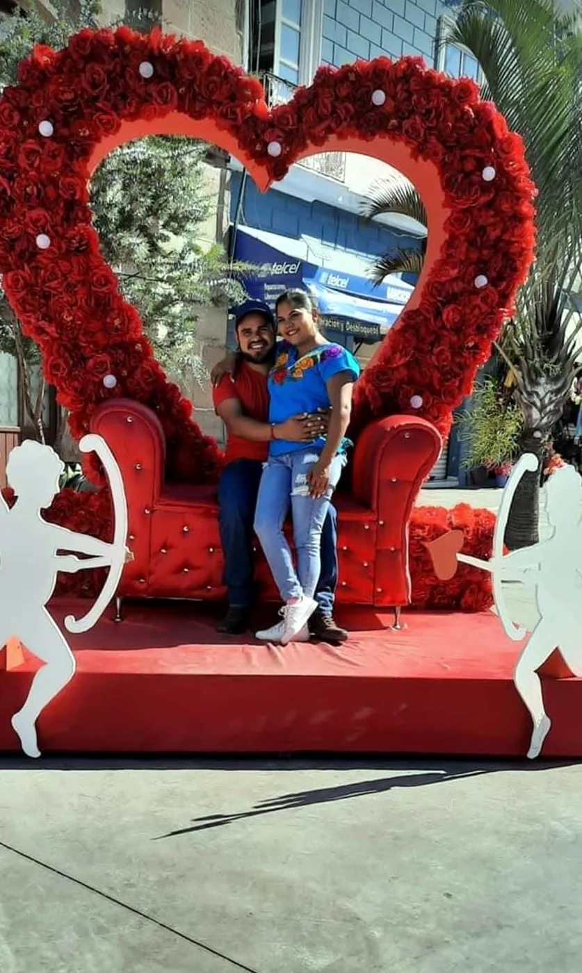 Jesús y Jacqueline en un trono con un gran corazón de rosas